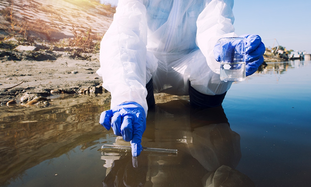 ecologist-taking-samples-water-with-test-tube-from-city-river-determine-level-contamination-pollution