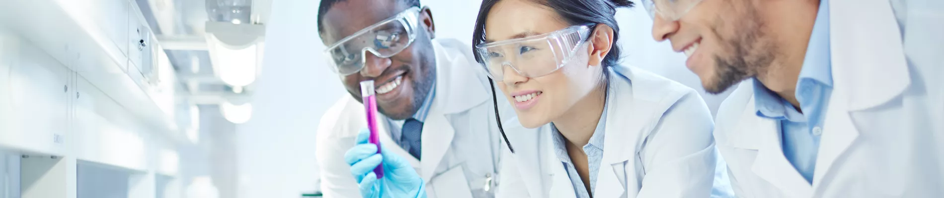 Students in lab coats collaborating